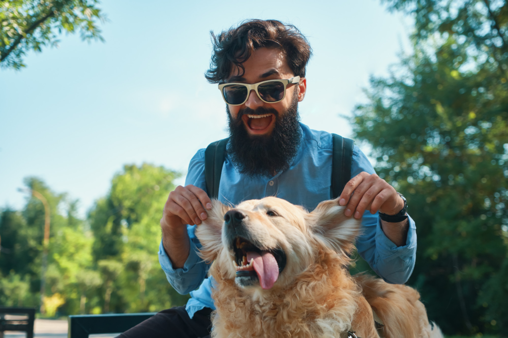 man playing with golden retriever puppy in a park - new pet owner's checklist, puppy essentials, puppy care India